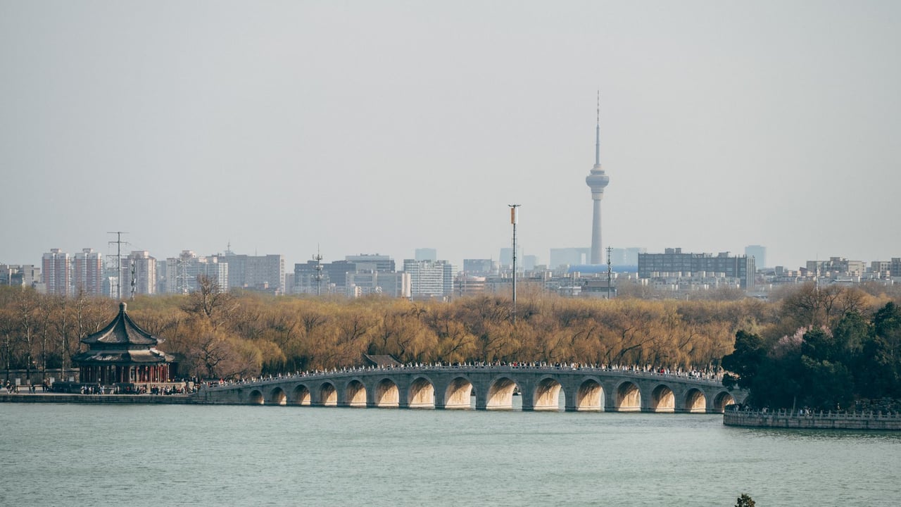 Scenic view of Seventeen Arch Bridge in Beijing with city skyline.