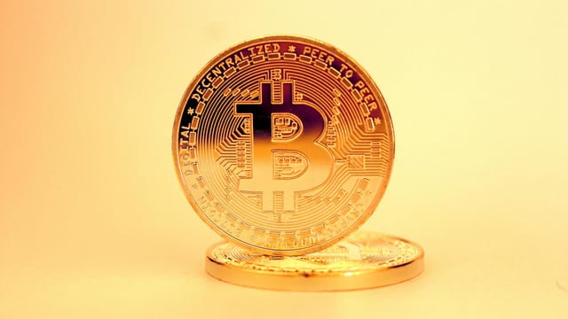A close-up of a golden Bitcoin highlighting its digital currency design.