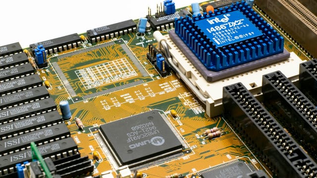 Detailed view of an Intel i486 DX2 CPU installed on a vintage motherboard with chips and circuits.