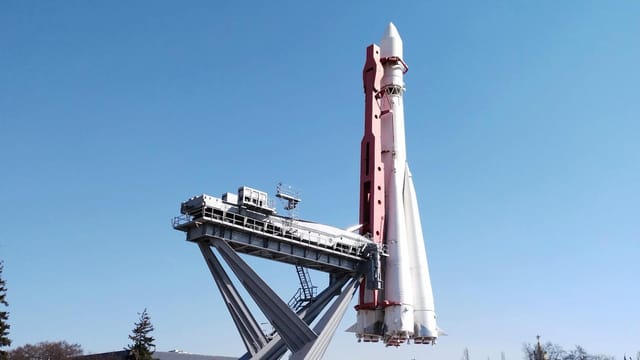 A Soyuz rocket is displayed at Moscow's VDNKh against a clear blue sky.