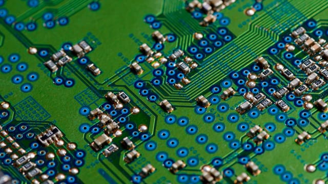 Detailed image of green circuit board showcasing electronic components for technology use.