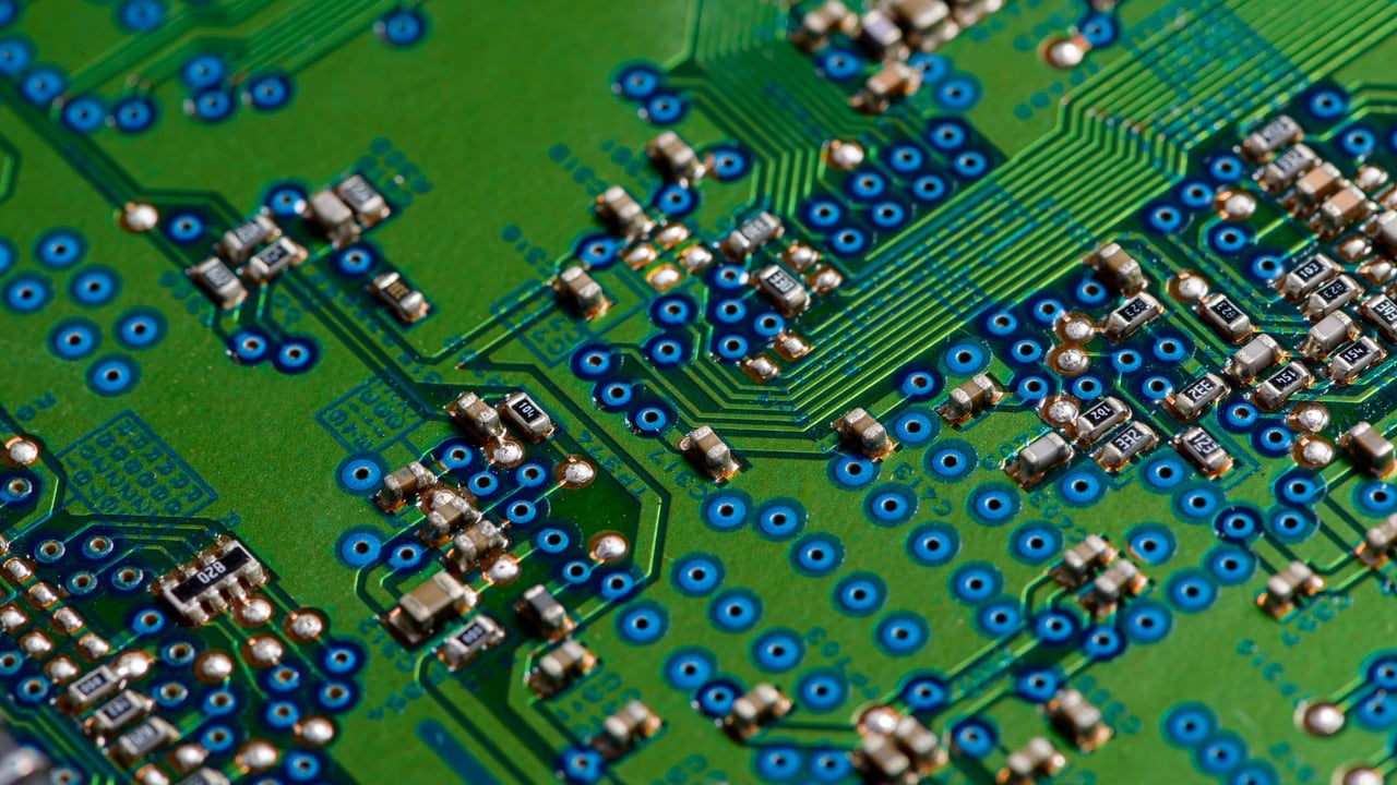 Detailed image of green circuit board showcasing electronic components for technology use.