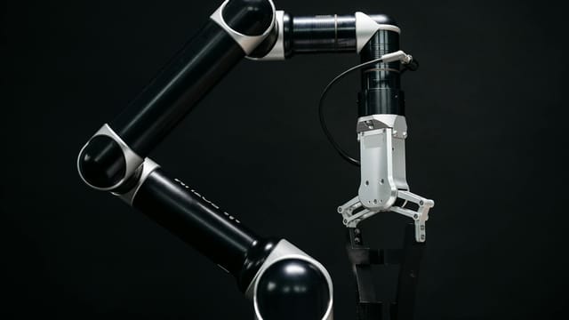 Close-up of a mechanical robotic arm with a dark background, showcasing advanced technology.