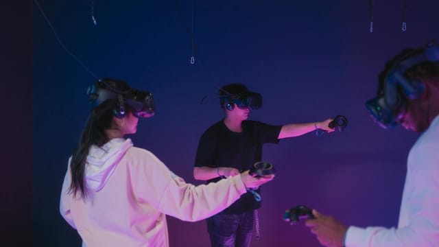 A group of young adults engaging in immersive virtual reality gaming indoors.