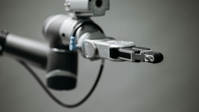 Close-up of a robotic arm showcasing advanced technology and innovation in an indoor environment.