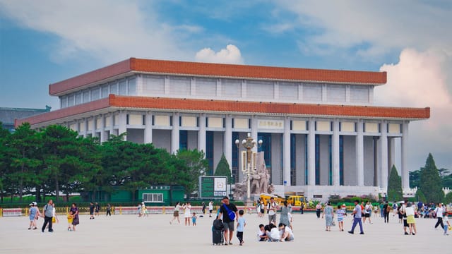 View of the Mausoleum of Mao Zedong in Beijing's Tiananmen Square with visitors.