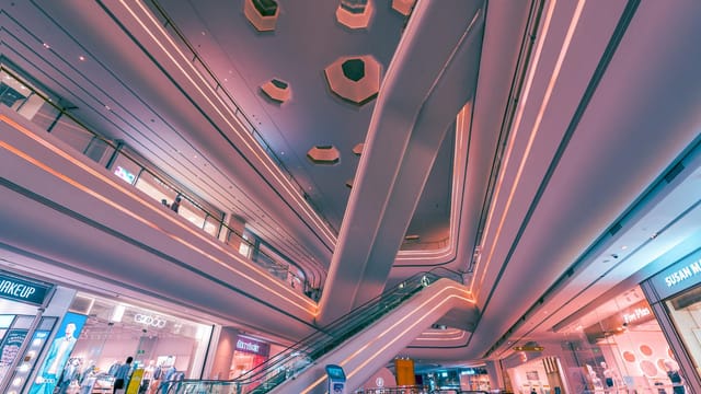 Explore the futuristic design and vibrant lighting of a Shenzhen shopping mall interior.
