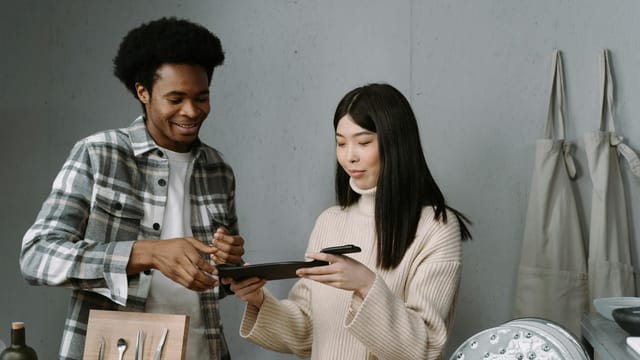 A man and woman engaged in a sales discussion over tableware in a modern store.