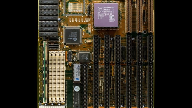 Detailed image of a vintage computer motherboard with visible CPU and circuits.