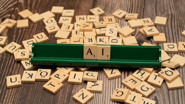 Wooden letter tiles spelling AI, representing technology and innovation.