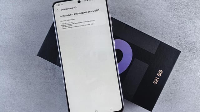 A smartphone on a box showing a software update screen, creating a tech-focused scene.