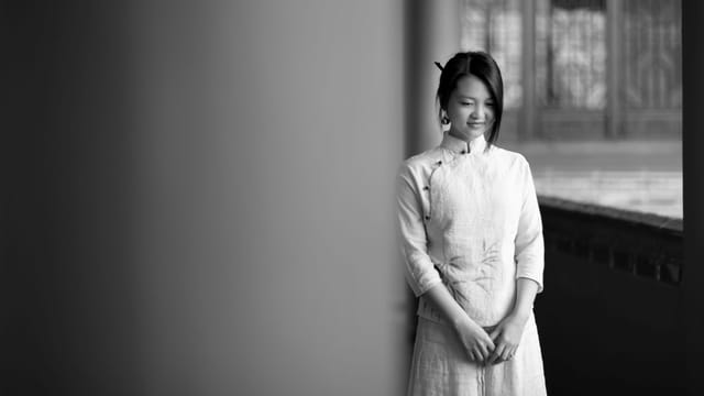 Portrait of a woman wearing traditional clothing, exuding elegance in a black and white composition.