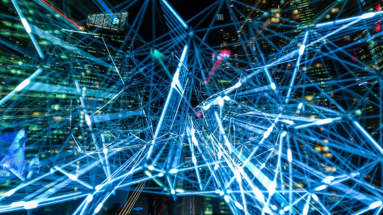 Dynamic urban scene showcasing interconnected light trails representing digital communication networks.