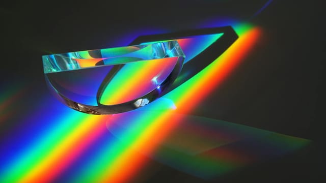 Vivid display of light spectrum through a prism, showcasing vibrant colors in an abstract artistic style.