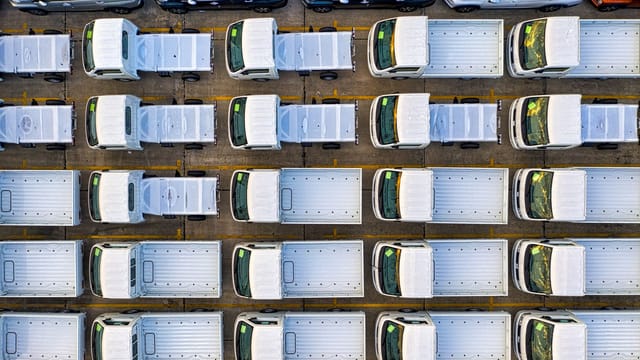 Overhead view of a fleet of trucks neatly parked in a seaport area of Jakarta, Indonesia.