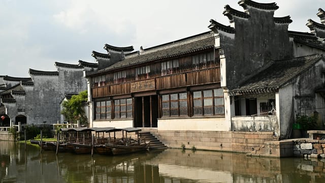 Explore the beauty of Chinese architecture alongside a peaceful canal scene in this traditional water town.