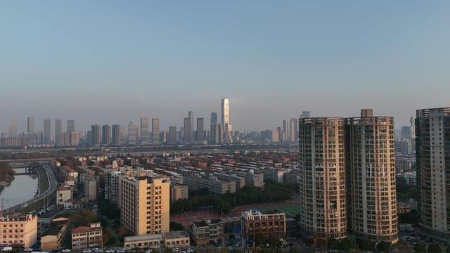 A stunning aerial view of the Changsha city skyline at dusk, showcasing modern skyscrapers and urban landscape.