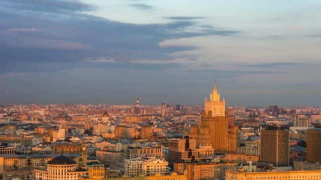 A breathtaking aerial shot showcasing Moscow's skyline with the Ministry of Foreign Affairs building at sunset.