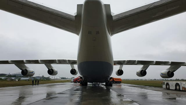 A large cargo plane on a rainy tarmac at Gostomel Airport, Ukraine.