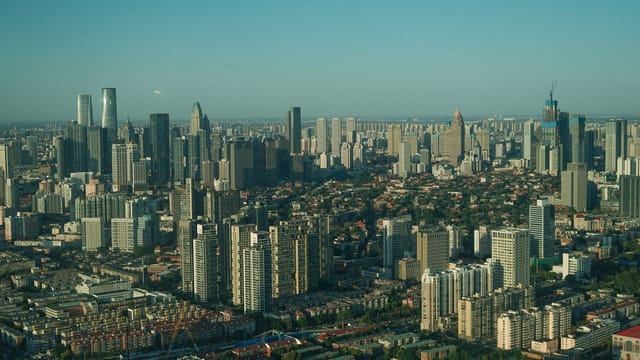 High-rise buildings and dense urban layout seen from above in a bustling cityscape.