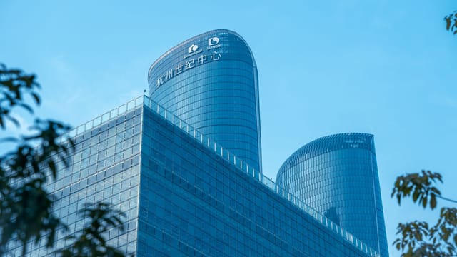 Low angle view of Hangzhou Century Center skyscrapers against a clear sky.