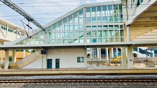 Contemporary railway station design in Zibo, Shandong, China, showcasing sleek glass structures.