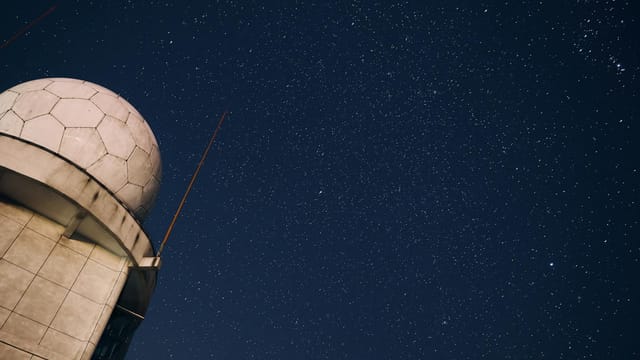 A stunning view of a starry night sky above an observatory dome, capturing the beauty of the cosmos.