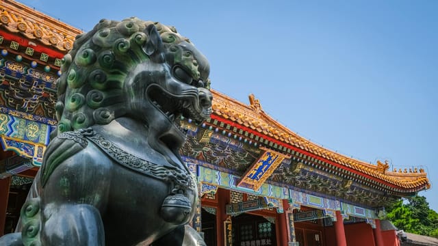 Close view of Foo Dog statue and traditional Chinese architecture at Beijing's Summer Palace.