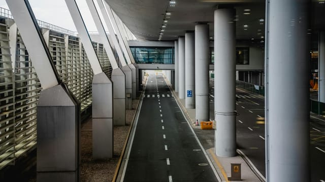 Explore the sleek design of a terminal at Shanghai Airport with towering pillars and modern architecture.