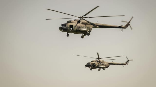 Two military helicopters flying in the sky above Belgrade, Serbia.