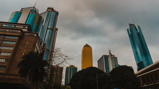 A captivating view of towering skyscrapers in Guangzhou, China, under a dramatic sky.