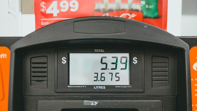 Close-up of a gas pump display showing price per liter and total volume during a transaction.