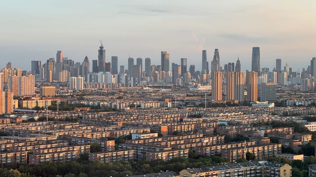 Aerial view of Shanghai's vibrant skyline at sunset, showcasing modern skyscrapers.