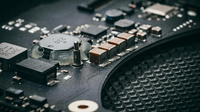 Detailed macro shot of an electronic circuit board showcasing various components.