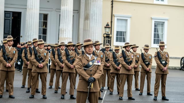 Soldiers in uniform standing in formation at Royal Military Academy Sandhurst, UK.