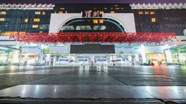 Vibrant night view of Shenzhen Railway Station, highlighting its modern architecture.