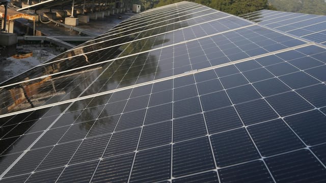 Wide view of solar panels on a rooftop in Lahore, promoting clean energy and sustainability.