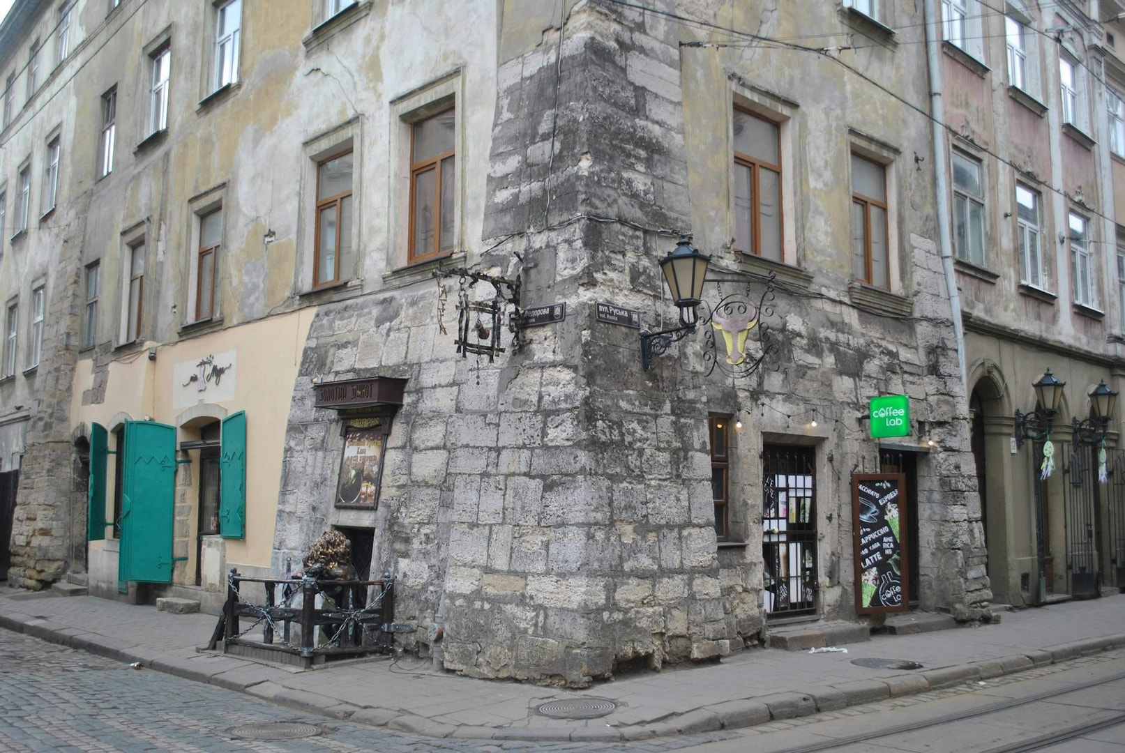 Old stone building with coffee shop in historic European city street.