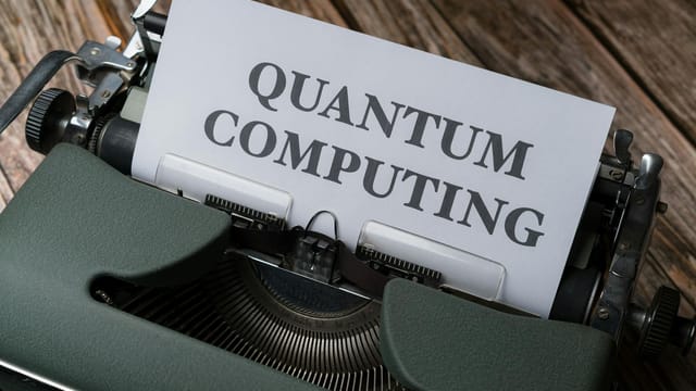 Quantum computing concept displayed on a vintage typewriter on wooden table.
