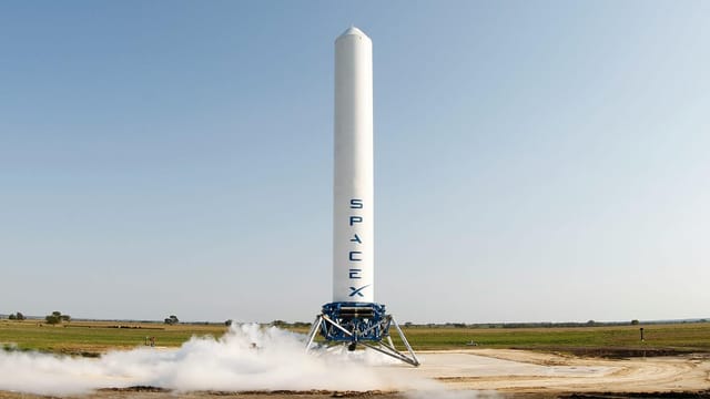A SpaceX rocket prepares for launch in a rural landscape, capturing a sense of technological advancement.