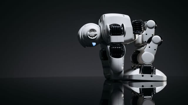 A modern robot toy depicted in a studio environment with its reflection visible on a dark surface.