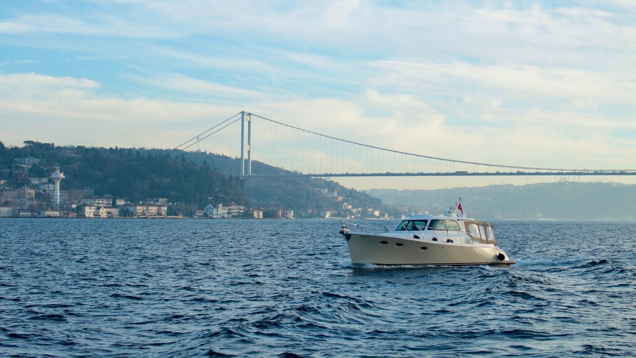 A serene boat ride on the Bosphorus with Istanbul's iconic bridge in the background.