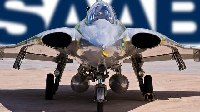 Close-up of a J 35 Draken fighter jet, showcasing its sleek design and parked under a SAAB logo.