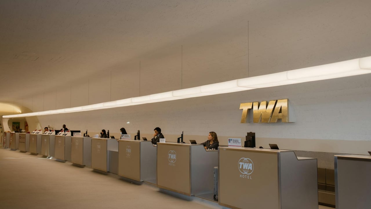 Reception desks at TWA Hotel, showcasing retro-modern design in JFK Airport, New York.