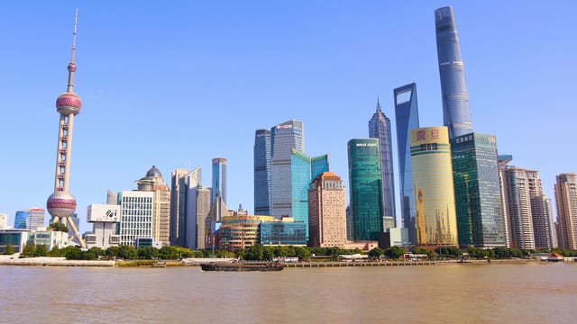 Stunning view of Shanghai's modern skyline featuring the iconic Oriental Pearl Tower on a sunny day.