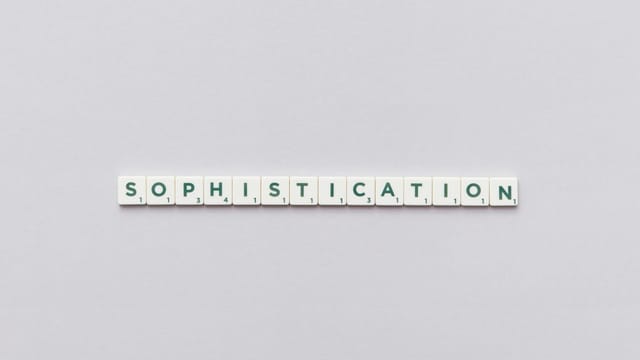 Letter tiles spelling out 'Sophistication' on a neutral background, perfect for conceptual themes.