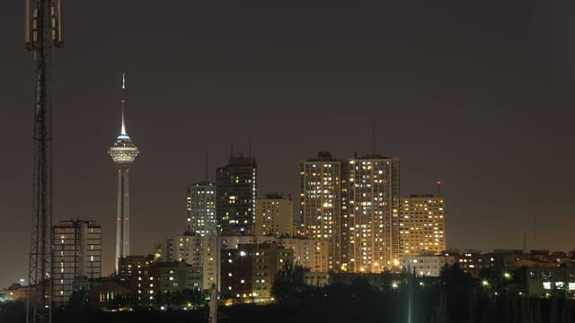 A stunning night view of Tehran's skyline with the iconic Milad Tower prominently visible.