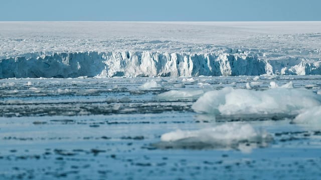 Expansive ice shelf and frozen sea in the Arctic, showcasing the beauty of the natural glacial landscape.