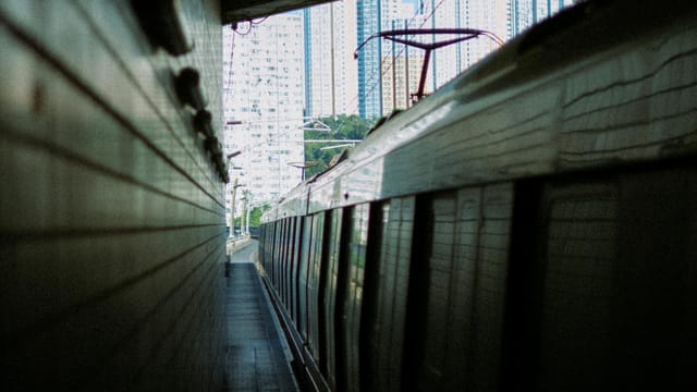Sleek train moves through cityscape, capturing urban transportation dynamics.