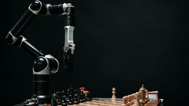 A robotic arm engages in a chess match, showcasing AI and robotics in a studio setup.